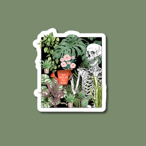 May include: A skeleton holding a red mug with the text "You make me feel alive" surrounded by various green plants and flowers.