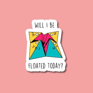 May include: A sticker with a colorful fortune teller paper fortune with the text "Will I be floated today?" on a pink background.