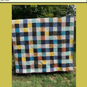 Könnte beinhalten: Ein farbenfrohes Patchwork-Quilt mit einem Schachbrettmuster. Der Quilt zeigt Quadrate in Schwarz, Blau, Gelb, Orange und Weiß. Der Text "Almost Patchwork Quilt Pattern" befindet sich oben.