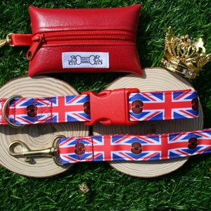 May include: A red leather dog poo bag holder with a zipper and a gold clip. A red and blue dog collar and leash with a Union Jack pattern and red poppy accents. The leash has a gold clip. The collar has a red plastic buckle.