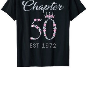 May include: Black t-shirt with a rhinestone design that says "Chapter 50 Est 1972" with a crown above the number 50.