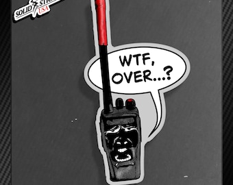 May include: A black and red walkie-talkie sticker with the text "WTF, OVER...?" in a speech bubble. The sticker has a cartoonish design with a face on the walkie-talkie and the words "SOLID STICKERS USA" in the upper left corner.