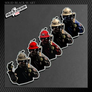 May include: A set of stickers depicting a construction worker wearing a hard hat, sunglasses, and holding a hammer. The stickers are in different colours, including red, blue, and beige. The text "SOLID STICKERS USA" is visible.