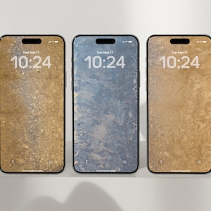 May include: Three smartphones with screens displaying the time 10:24. The screens feature textured backgrounds in shades of gold and blue. The phones are black with a sleek design.