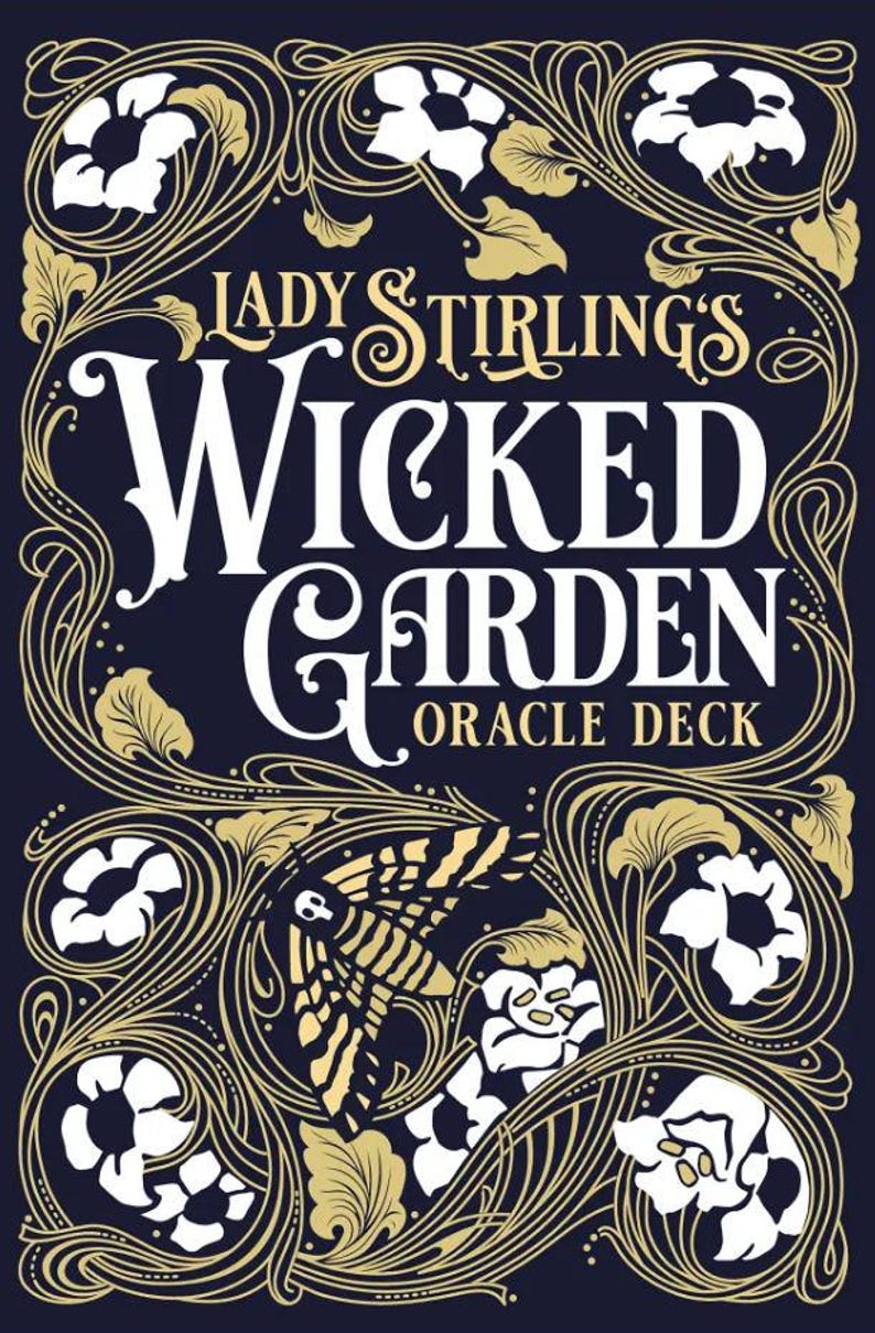 May include: A dark blue oracle deck box with gold and white floral and insect illustrations. The text reads "Lady Stirling's Wicked Garden Oracle Deck" in a decorative font. The design has an art nouveau style.