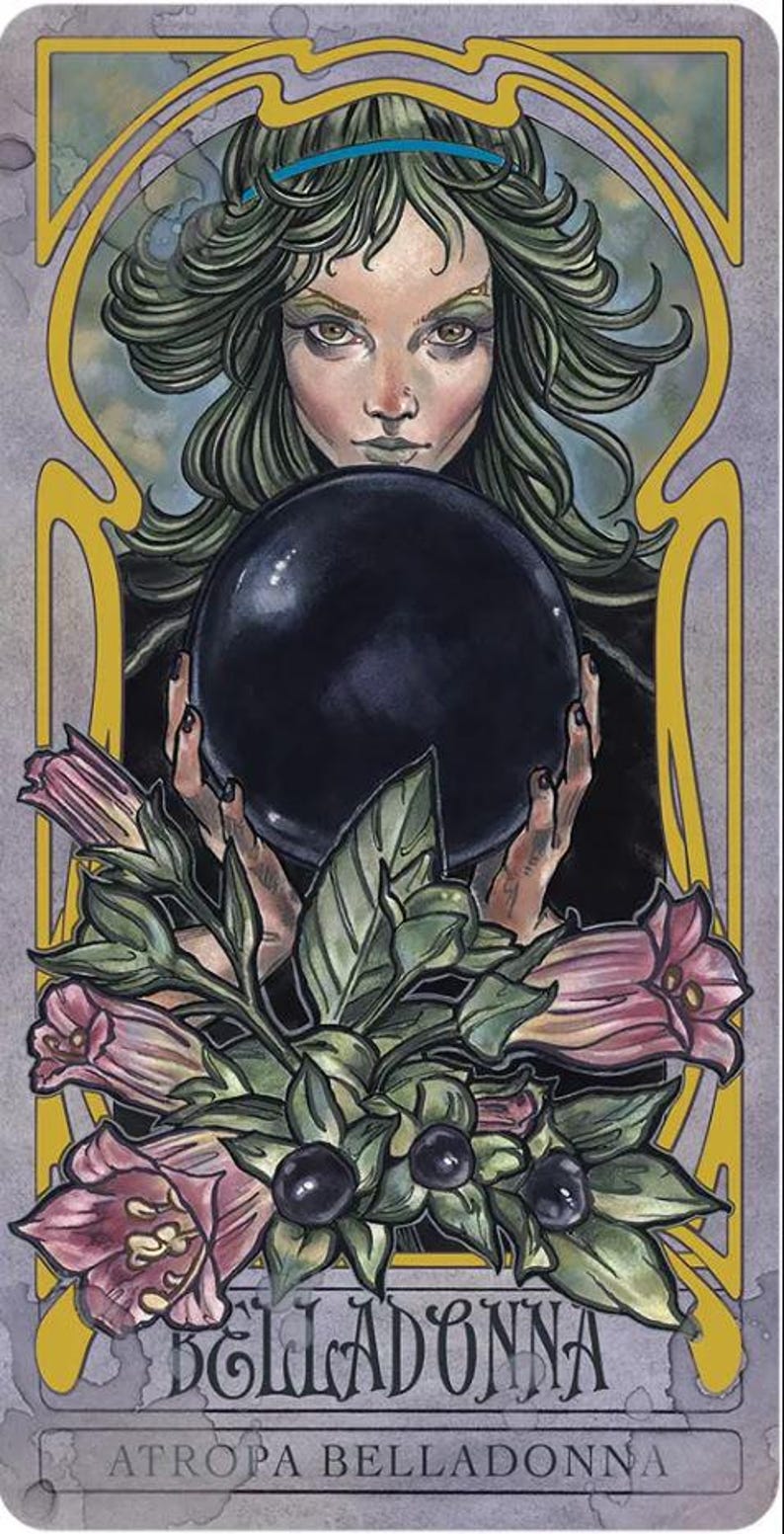 May include: A tarot card illustration featuring a woman with green hair holding a black orb. The card is framed with Art Nouveau-style gold lines and includes the word "BELLADONNA" and "ATROPA BELLADONNA" at the bottom. Pink and green floral elements are at the bottom.