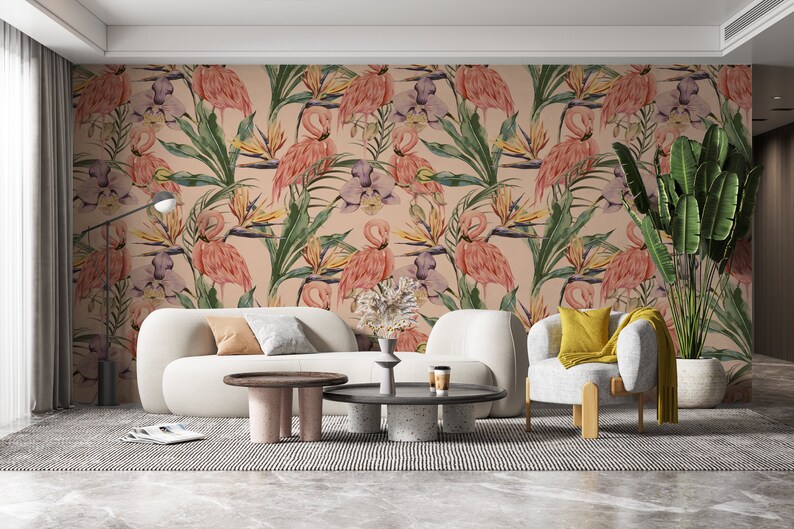 May include: A living room interior design with a pink and green floral wallpaper featuring pink flamingos and tropical plants. The wallpaper is on the wall behind a white sofa and a white armchair with a yellow pillow. There is a coffee table in front of the sofa and a side table next to the sofa.