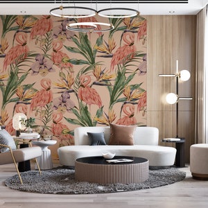 May include: A living room interior design with a white sofa, a round coffee table, a gray rug, and a wall with a tropical wallpaper featuring pink flamingos and green leaves.