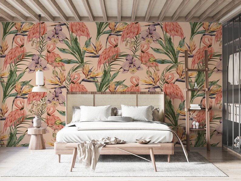 May include: A bedroom with a pink flamingo and tropical leaf patterned wallpaper. The bed has a white duvet and a wooden headboard. There is a wooden side table with a plant on it.