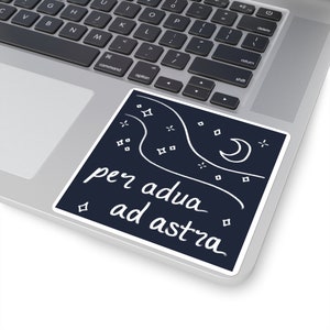 May include: A black and white sticker with a crescent moon and stars. The text "per adua ad astra" is written in white cursive.