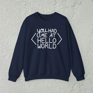 May include: Navy blue sweatshirt with white text that reads "you had me at hello world" with angled brackets around the words "hello world".