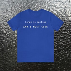 May include: A royal blue t-shirt with the text "Linux is calling AND I MUST CODE" in white.