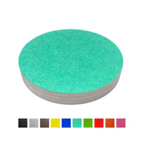 May include: A pile of circular, green coasters with a textured finish. These coasters are made from a composite material and are designed to protect surfaces from heat and moisture. A colour palette of coasters is shown below the stack.