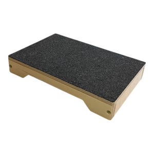 May include: A wooden step stool with a black textured top. The stool has rounded edges and a light brown finish.
