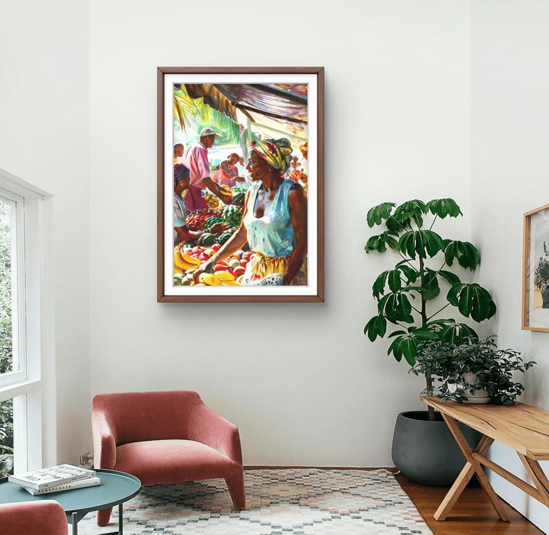 May include: Watercolor painting of a market scene. A woman in a light blue top and headscarf is arranging produce. Other figures are visible in the background. The artwork is framed in a dark wood frame and hangs on a white wall.
