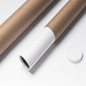 May include: Two brown cardboard tubes, one partially open to reveal a white interior with a rolled-up print. A white cap sits nearby. The tubes are on a white surface.
