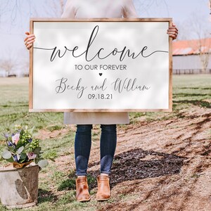 May include: White wooden sign with black calligraphy that reads "Welcome to our forever Becky and William 09.18.21".