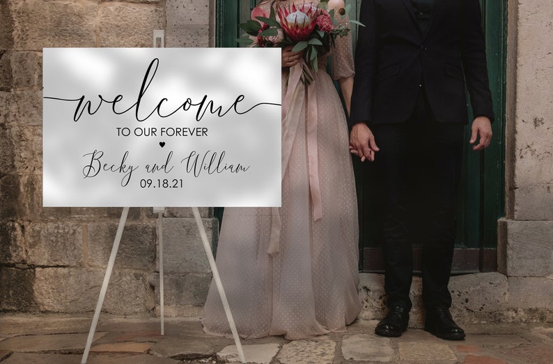 May include: A white welcome sign with black calligraphy that reads "Welcome to our forever Becky and William 09.18.21".