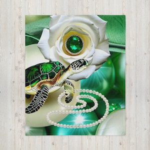 May include: A decorative throw blanket featuring a sea turtle, a white rose with a green gem center, and a pearl necklace with the text "LOLOOOS GIRL 1920". The blanket has a green and white color scheme.