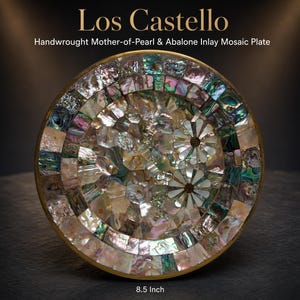 May include: A circular 8.5 inch Los Castello plate featuring a handwrought mosaic inlay of iridescent mother-of-pearl and abalone shell pieces. The design includes two floral motifs composed of white shell petals on a shimmering surface.