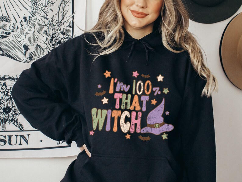 May include: Black hoodie with a colorful graphic that says "I'm 100% That Witch" with a witch's hat and stars.