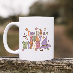 May include: White ceramic mug with a colorful graphic that says "I'm 100% That Witch" with a purple witch hat and stars.