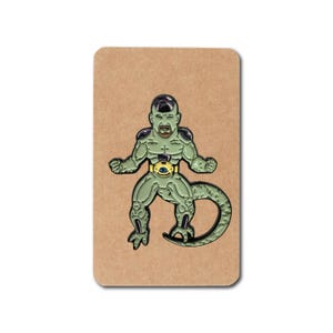 May include: A green and purple enamel pin featuring a cartoon character with a human head and a reptilian body. The character has a serious expression and is wearing a yellow belt with a purple gem.