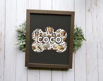 May include: A framed black and white sign with a bone-shaped design. The bone is filled with a pattern of coffee cups, pastries, and swirls. The word "COCO" is written in bold, white letters in the center of the bone.