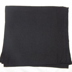 May include: A black fabric scarf, folded in half, with a smooth texture.