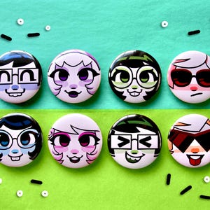 May include: Eight circular badges featuring cartoon faces with various expressions and hairstyles. Some have glasses or sunglasses. The background is split between light green and teal, with small black and white sprinkles.