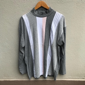 May include: A grey long-sleeved shirt with vertical stripes in white, pink, and grey. The shirt has a mock neck.