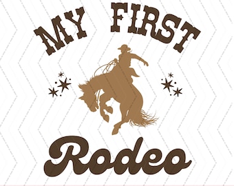 May include: A brown silhouette of a cowboy riding a bucking bronco with the text "My First Rodeo" in brown lettering with stars on either side.