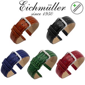 Puede incluir: Cinco correas de reloj en varios colores: marrón, negro, azul, verde y rojo. Cada correa presenta un patrón texturizado similar al de un reptil, una hebilla plateada y el texto "Eichmüller since 1950".