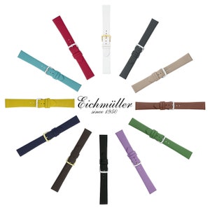 Może przedstawiać: Kolekcja kolorowych pasków do zegarków w różnych odcieniach, w tym turkusowym, czerwonym, białym i czarnym, ułożonych w okrąg. Każdy pasek ma sprzączkę i jest wykonany z gładkiego materiału. Widoczna jest również nazwa marki "Eichmüller since 1950".