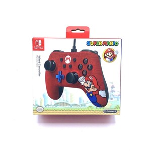 May include: A red and black wired controller for the Nintendo Switch, featuring a Super Mario design. The controller has a red textured surface and a black face with buttons labeled A, B, X, Y, and a directional pad. The controller also features a red and black Super Mario character on the front.