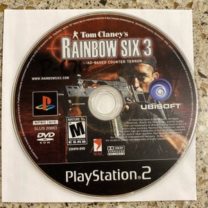 May include: A PlayStation 2 game disc for Tom Clancy's Rainbow Six 3, a squad-based counter-terror game. The disc is black with a red and white logo for Red Storm Entertainment, a Ubisoft company. The disc is rated M for Mature by the ESRB.