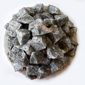 May include: A pile of small, gray and white stones, likely used for landscaping or decorative purposes.