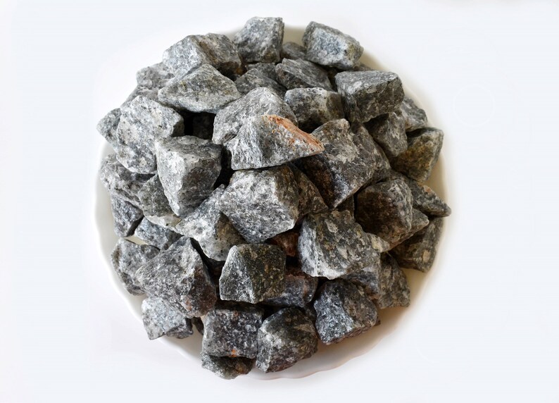 May include: A pile of small, gray and white stones, likely used for landscaping or decorative purposes.