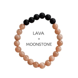 Può includere: Un braccialetto realizzato con perline di pietra lunare marrone e perline di roccia lavica nera. Il braccialetto ha il testo "LAVA + MOONSTONE" stampato su uno sfondo bianco.