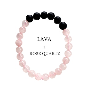 May include: A bracelet made of black lava beads and pink rose quartz beads. The bracelet has the text "LAVA + ROSE QUARTZ" written on it.
