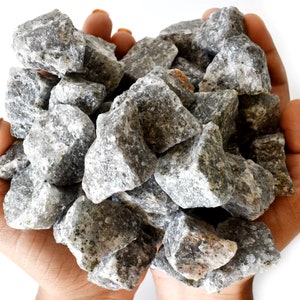 May include: A handful of gray and white rocks, likely used for landscaping or decorative purposes.