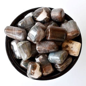Bulk of Cats Eye Tumbled Stones A Grade Healing Crystals Tumbled Stones in pack sizes of 4oz, 1/2 lb and 1 lb.