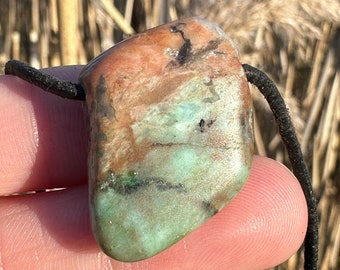 Energetic colored feldspar pendant as a protective stone