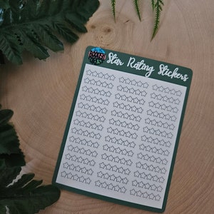May include: A sheet of star rating stickers with a green border and the text "Star Rating Stickers" in white. The sheet is on a wooden surface.