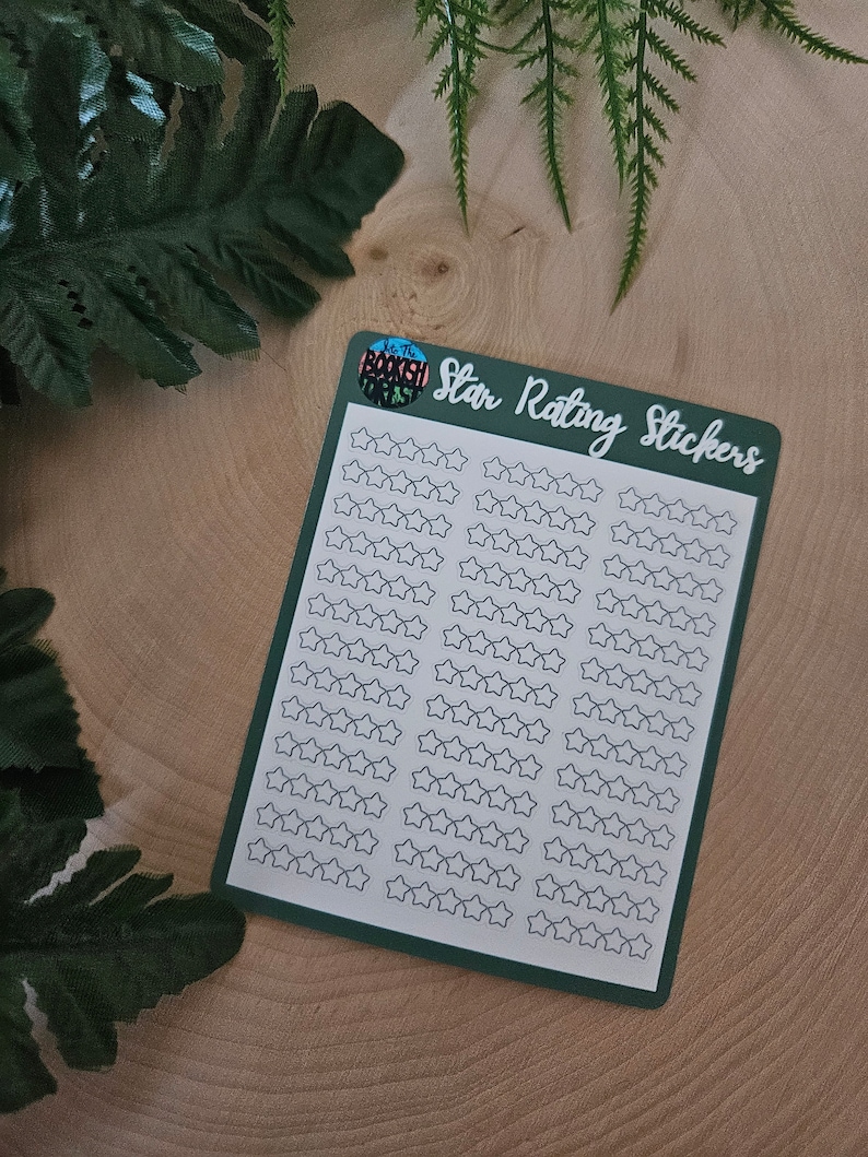 May include: A sheet of star rating stickers with a green border and the text "Star Rating Stickers" in white. The sheet is on a wooden surface.