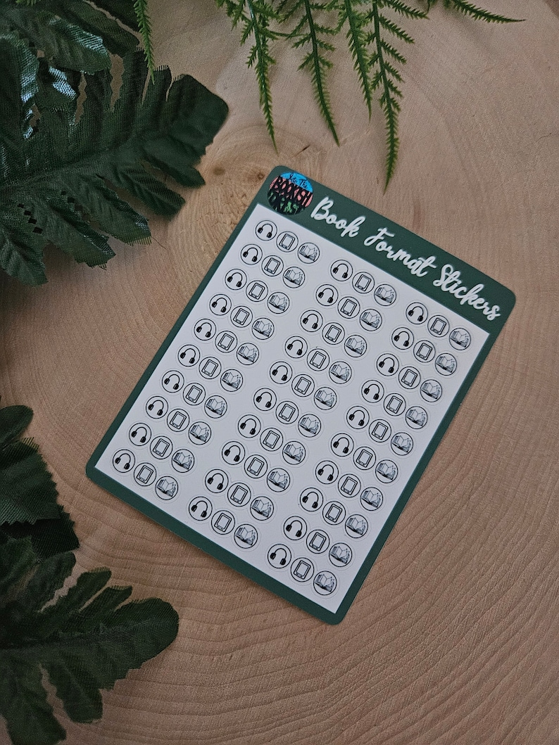 May include: A sheet of green sticker paper with white outlines of various book format icons. The icons include a book, a tablet, and headphones. The text "Book Format Stickers" is printed in white on the sheet.
