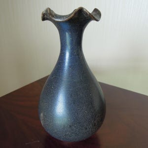 May include: A rustic wooden sign with the text "Welcome to our home" in white lettering. The sign features a distressed finish and a simple, inviting design, perfect for entryway decor.