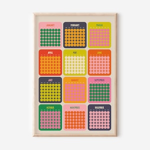 May include: A framed print of a calendar design with each month in a different colour and a grid of dots. The months are labelled across the top and bottom. The frame is a light wood colour.