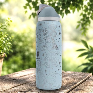 May include: A light blue water bottle featuring a grey lid and a wrap-around line art print of various animated characters including a potato figure, a cowgirl, a horse, a small soldier, a woman in a dress, and a pig, accented with small star shapes.
