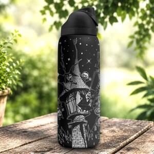 Laser engraved black stainless steel tumbler featuring spooky holiday-inspired characters, pumpkins, haunted scenes, and gothic wraparound artwork in a detailed silver engraving design.